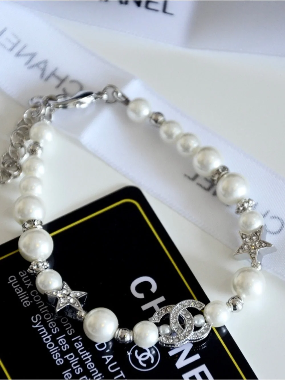 CHANEL Pearl Bracelet with Crystal CC Logo and Star Accents in White and Silver